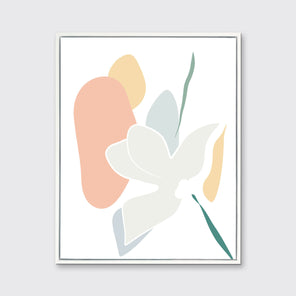 A light abstract botanical art print framed in a white frame hangs on a light wall.