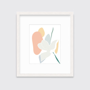 A light abstract botanical art print framed in a white frame hangs on a light wall. 