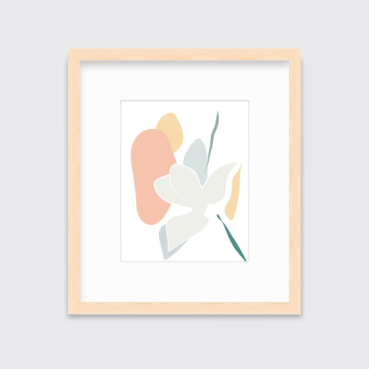 A light abstract botanical art print framed in a neutral wood frame hangs on a light wall.