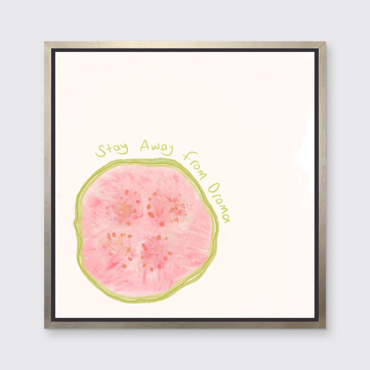 An abstract art print of a fruit framed in a silver floater frame hangs on a light wall.