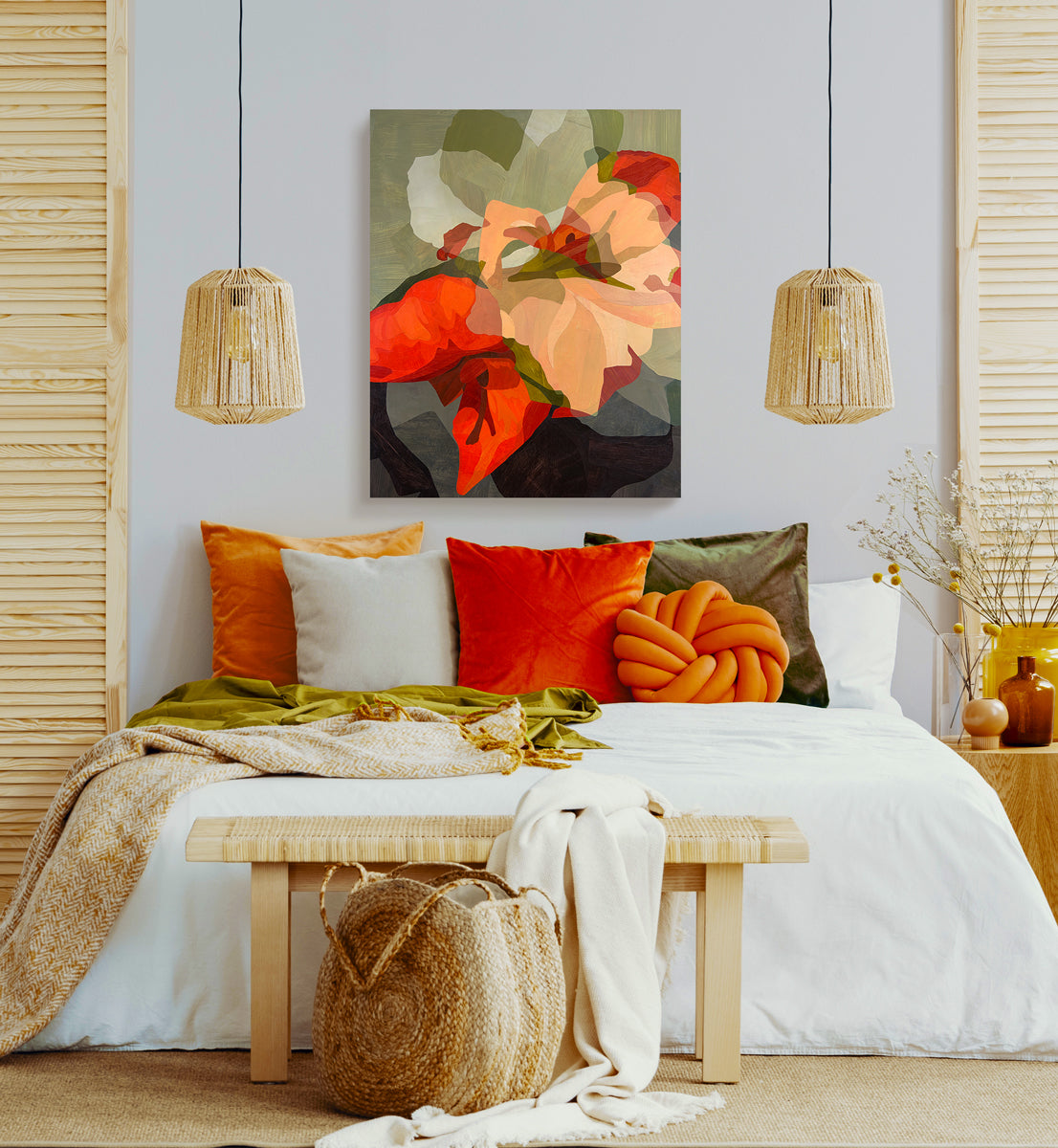 Decorative bedroom with colorful pillows, a bench, and a floral painting.
