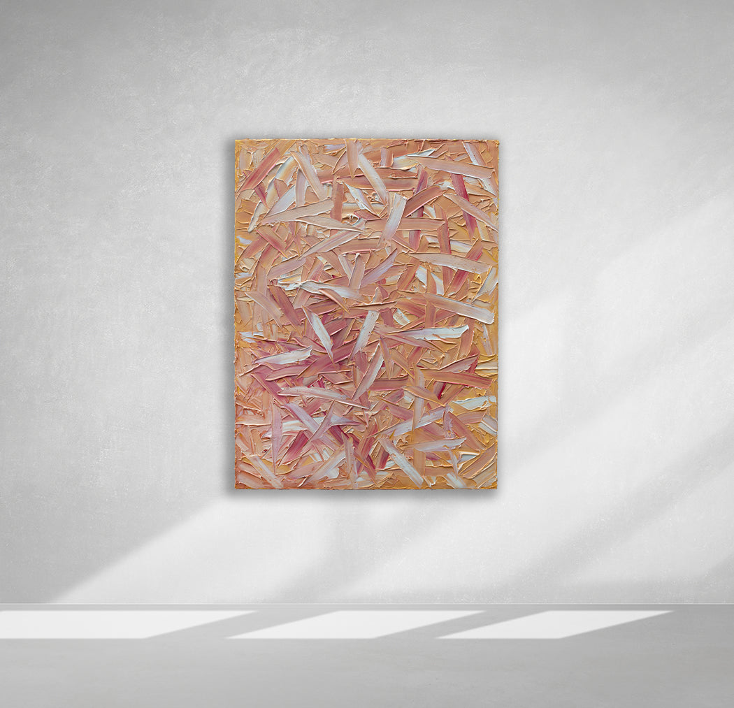 A orange, pink, coral and white thickly textured abstract painting hangs on a white wall.