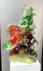 A multi-colored abstract glass sculpture on a white pedestal.  