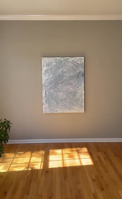 A video of a blue and white textured painting leaning on a deck in the artists studio.
