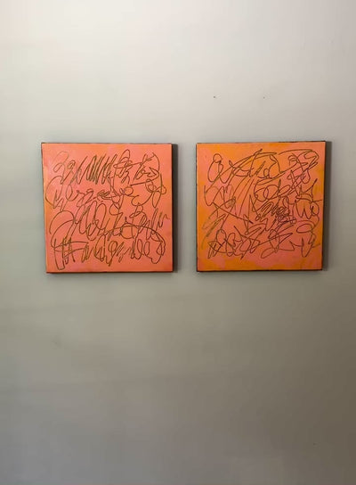 A video of two abstract text based paintings in orange and pink tones hanging on a white wall.