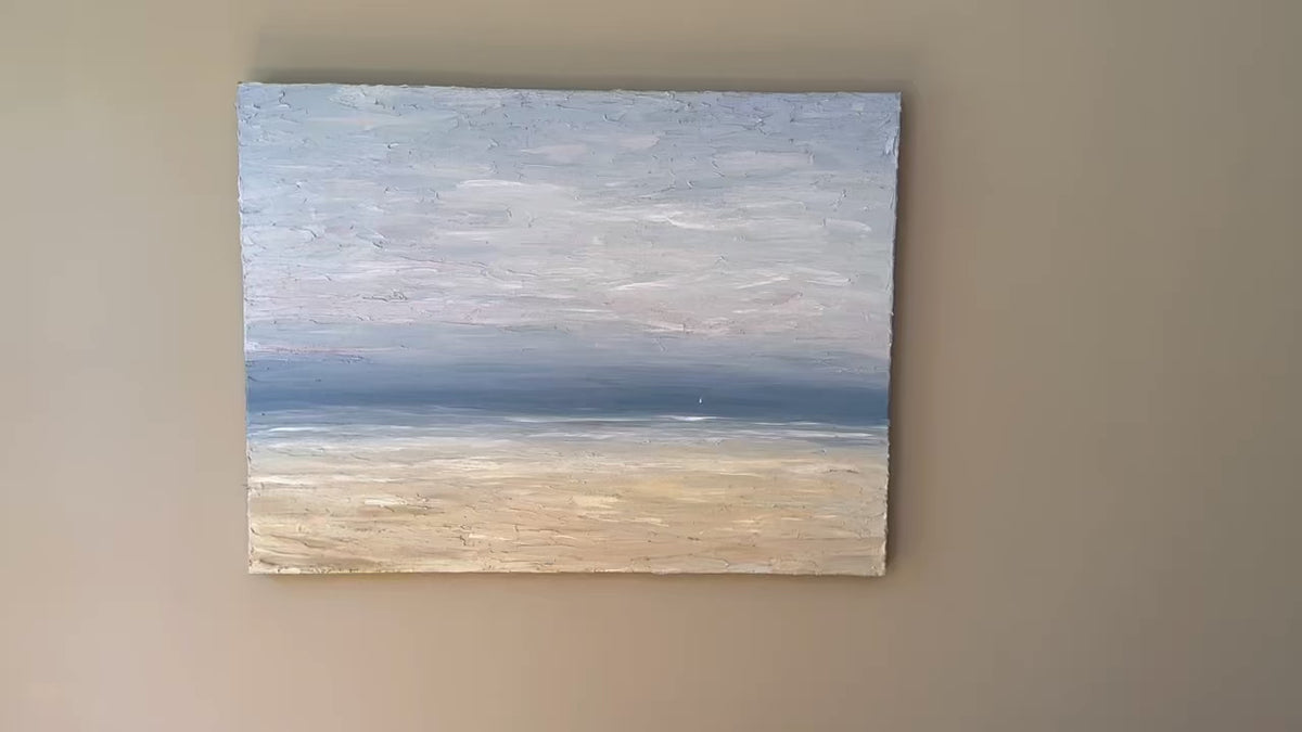 A video of a very textured coastal painting with a lone sailboat hangs on a wall.