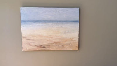 A video of an abstracted coastal painting hanging on a grey wall.