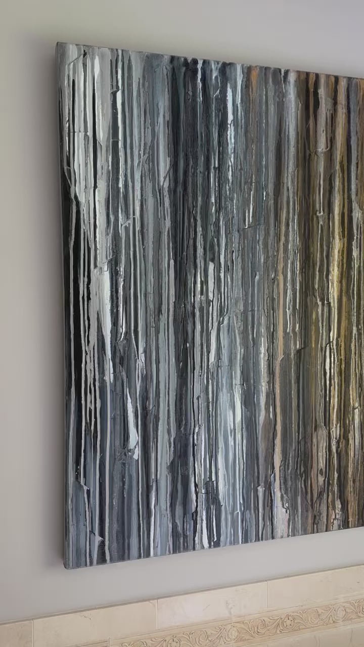 A video of a 48" x 48" original abstract painting with beige, black, brown, gray, and white dripped oil paint, titled 'Just Add Shoes' by Teodora Guererra hanging on a wall.