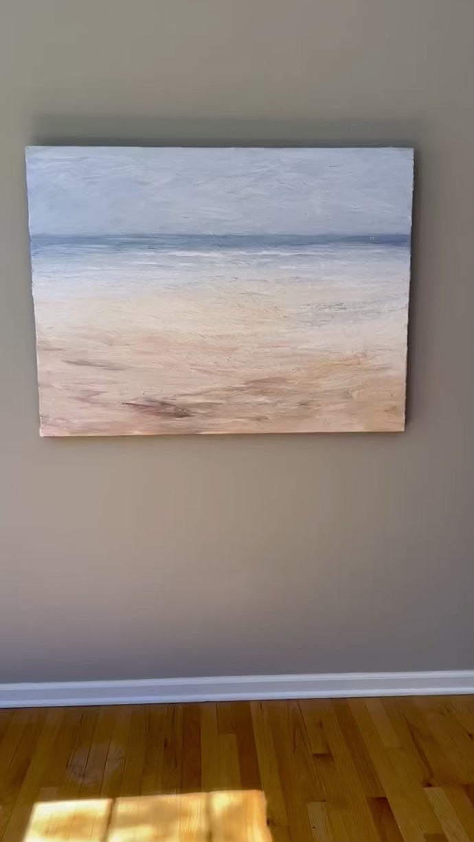 A video of an abstracted coastal painting hanging on a grey wall.