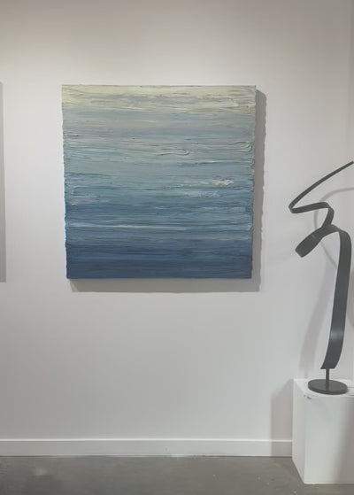 A video of a blue, beige, lavender and light yellow textured abstract painting by Teodora Guererra hangs on a white wall.