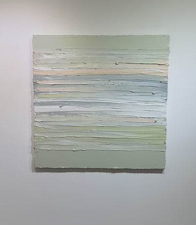 A video of celadon, grey, white, peach and sage green thickly textured painting hanging on a white wall by Teodora Guererra.