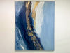 A video of an Abstract painting with blue, gold, and white hanging on a white wall.