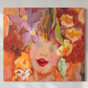Original abstract painting of a woman's face with flowers hanging on a white wall.