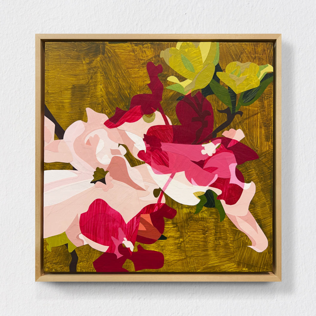 Framed abstract artwork with colorful flowers on a white wall.