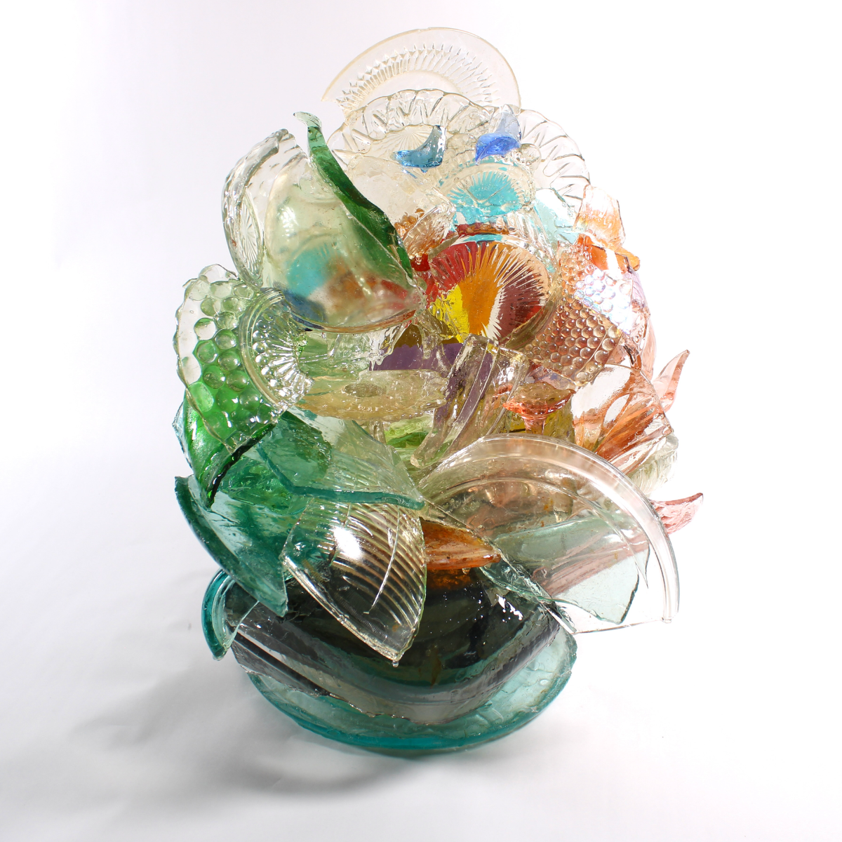 Colorful glass sculpture with leaf-like shapes on a white background.