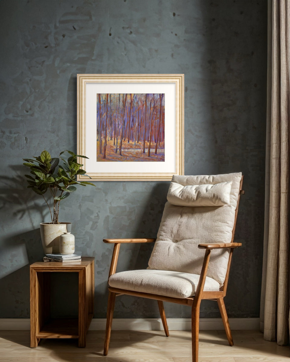 Wooden armchair with beige cushion in a room with a framed painting on the wall.