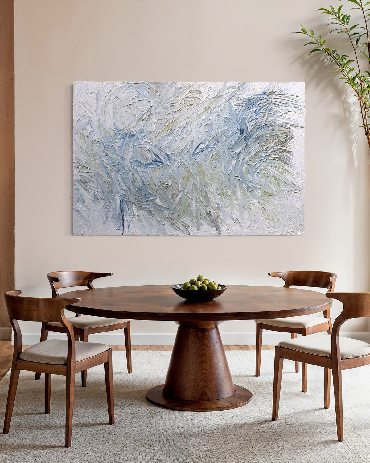 Dining room with wooden table and chairs, featuring an original abstract painting by Teo Guererra on the wall.