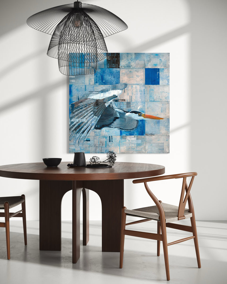 Dining room with a round wooden table, chairs, and a large abstract painting on the wall.