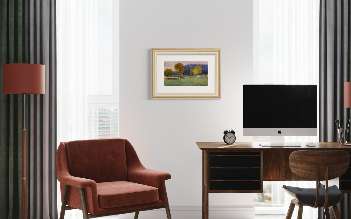 Modern home office with a desk, chair, and framed picture on the wall.