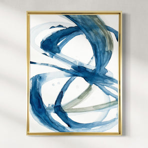 Abstract art print with blue and green brush strokes in a gold frame on a white wall.