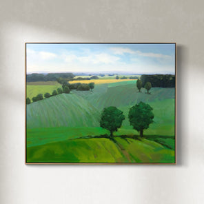 A green landscape painting hangs on a white wall. 