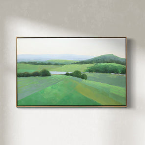 A green landscape painting framed in a light wood floater frame hangs on a white wall.