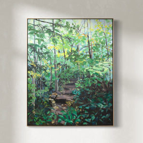 A large framed green painting of a forest hangs on a white wall.