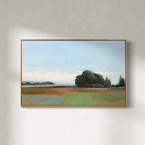 A blue, green, and sienna-toned landscape painting in a light wood frame hangs on a white wall. 