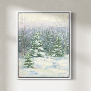 A blue, white and green snow fall landscape painting with snow covered pine trees in the center by Molly Doe Wensberg hangs in a white floater frame hangs on a white wall.