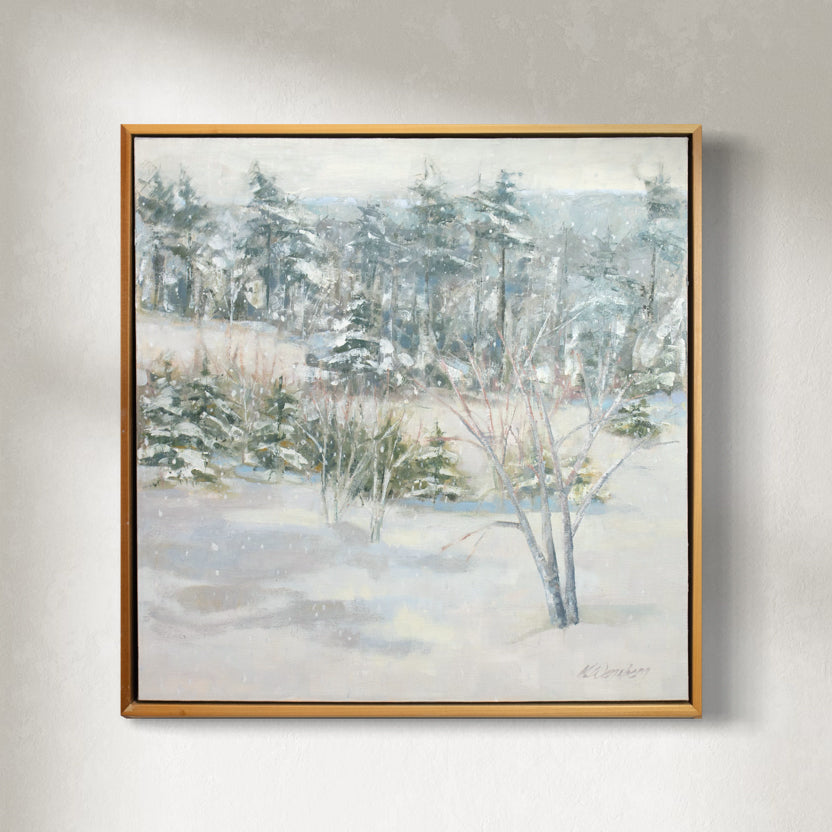A white, grey and green snow landscape painting by Molly Doe Wensberg hangs in a light wood floater frame on a white wall.