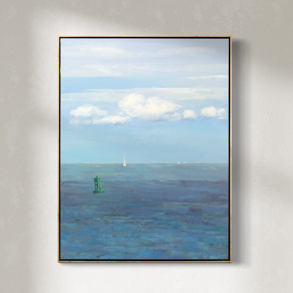 A blue, white and green coastal landscape painting by Molly Doe Wensberg hangs in a light wood floater frame on a white wall.