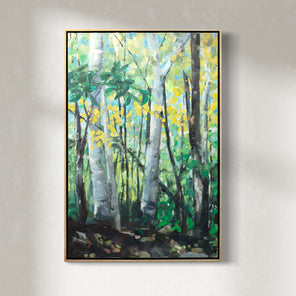 A framed green painting of a forest hangs on a white wall. 