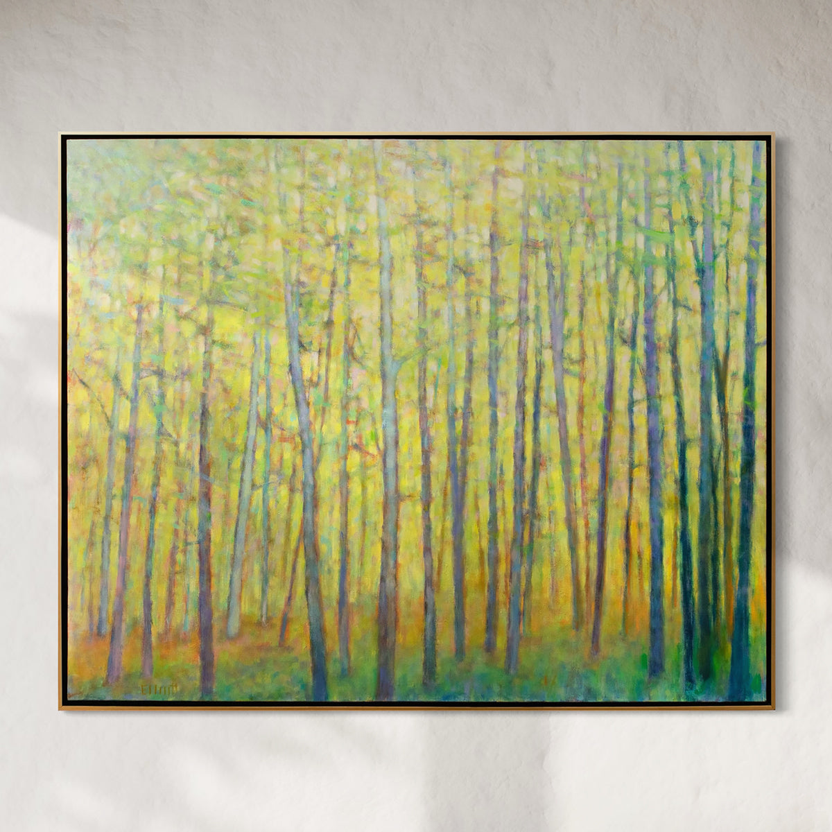 Framed painting of a forest scene with tall trees on a gray wall.