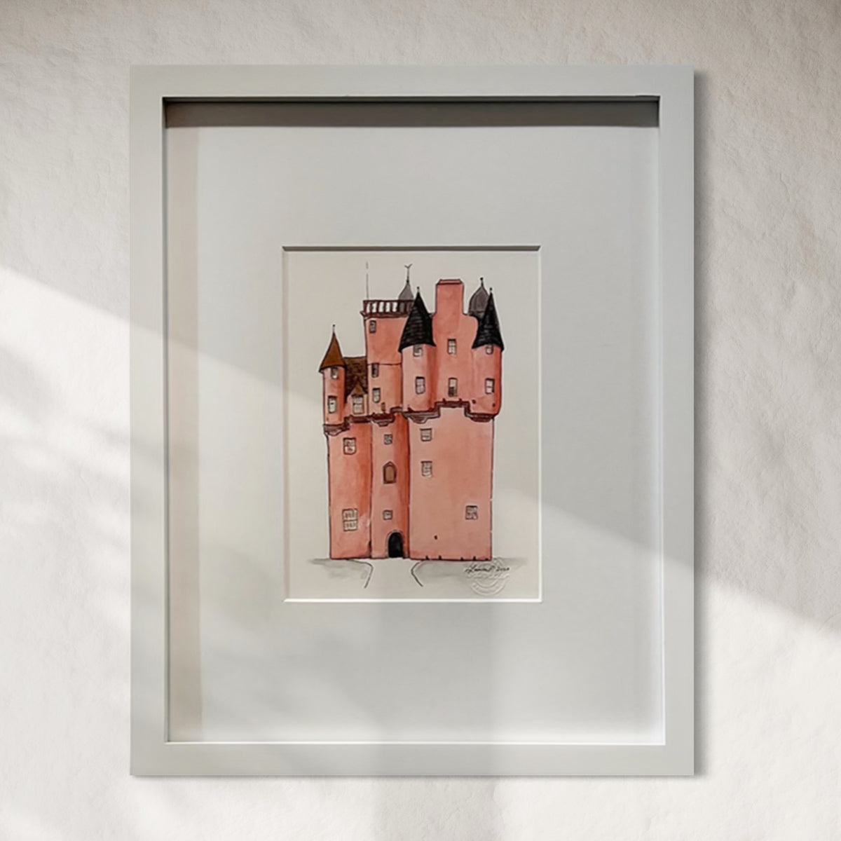 Framed painting/illustration of a castle on a white wall