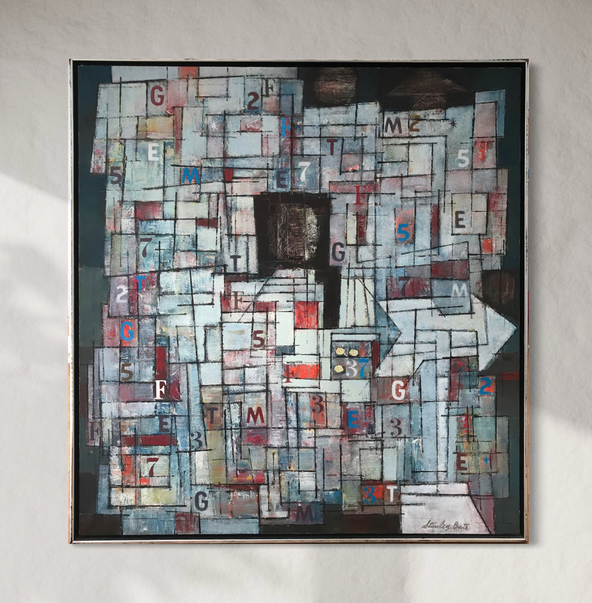 Abstract artwork with geometric shapes and text on a gray wall