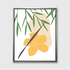 A green and yellow abstract botanical art print framed in a silver floater frame hangs on a light wall.