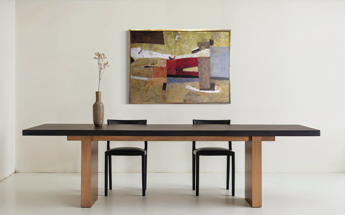 Dining table with chairs and a painting on the wall in a minimalistic room.