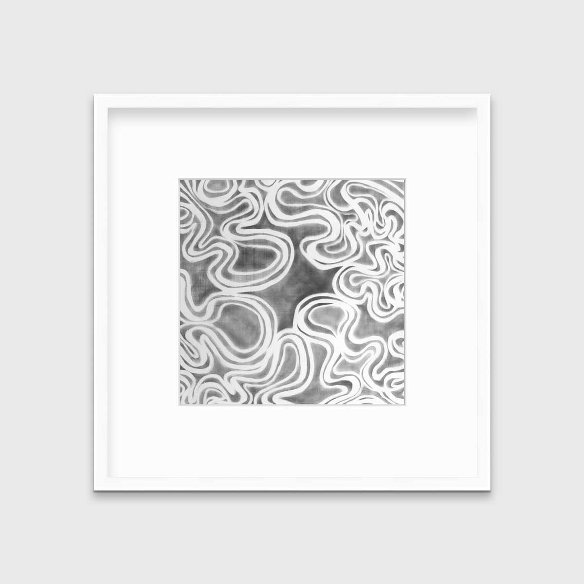 A grey and white abstract print in a white frame with a mat hangs on a white wall.