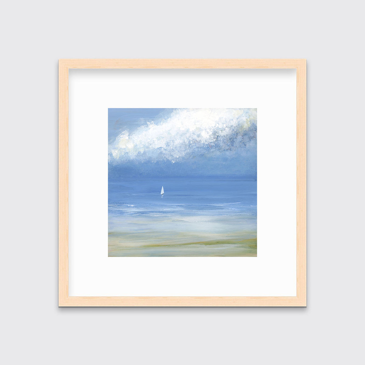 A blue, light green and white abstract seascape print with a small sailboat in a natural wood frame with a mat hangs on a white wall.