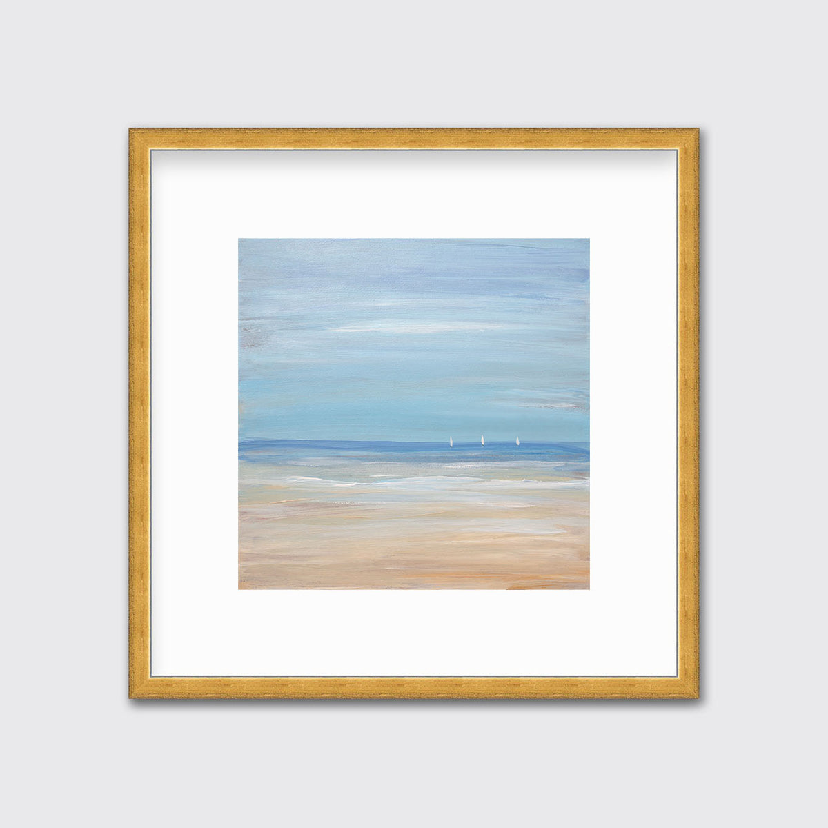 A blue, beige and white abstract seascape print with three small sailboats in a gold frame with a mat hangs on a white wall.