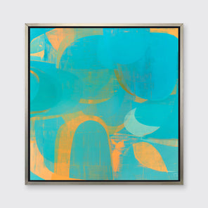 A blue, teal and light orange abstract print in a silver floater frame hangs on a white wall.