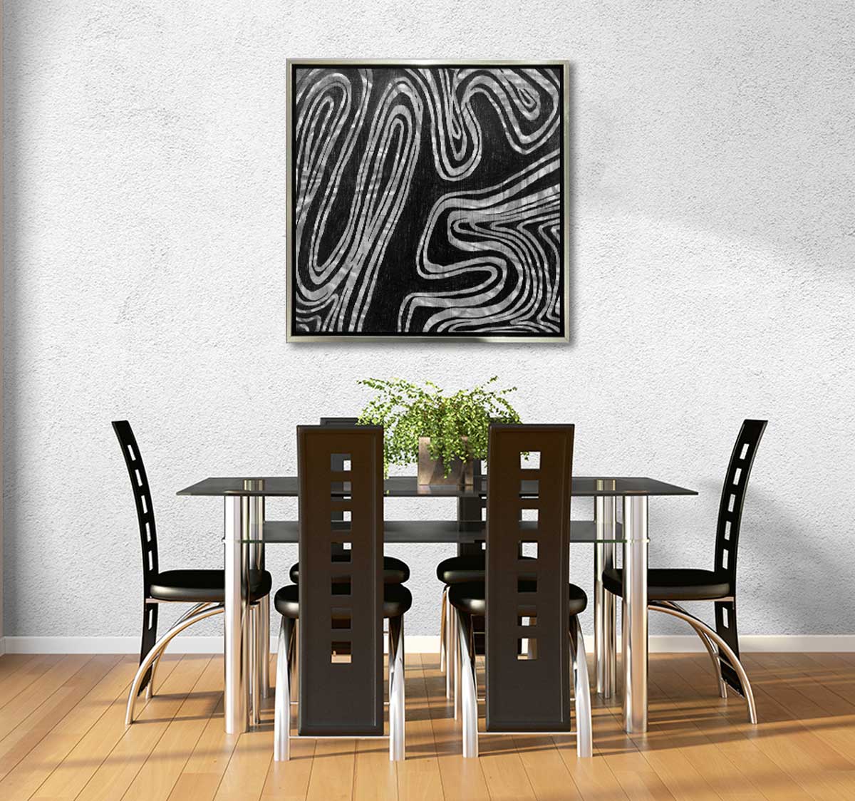 A black and white abstract print in a silver floater  frame hangs on a white  wall above a black and chrome table  with six black modern  chairs. 