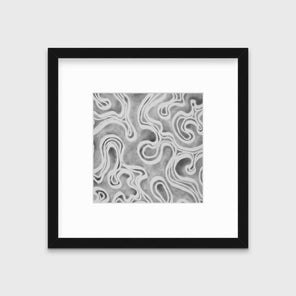 A grey and white abstract print in a black frame with a mat hangs on a white wall.