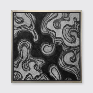 A black and grey abstract print in a silver floater frame hangs on a white wall.