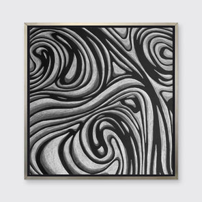 A black and grey abstract print in a silver floater frame hangs on a white wall.