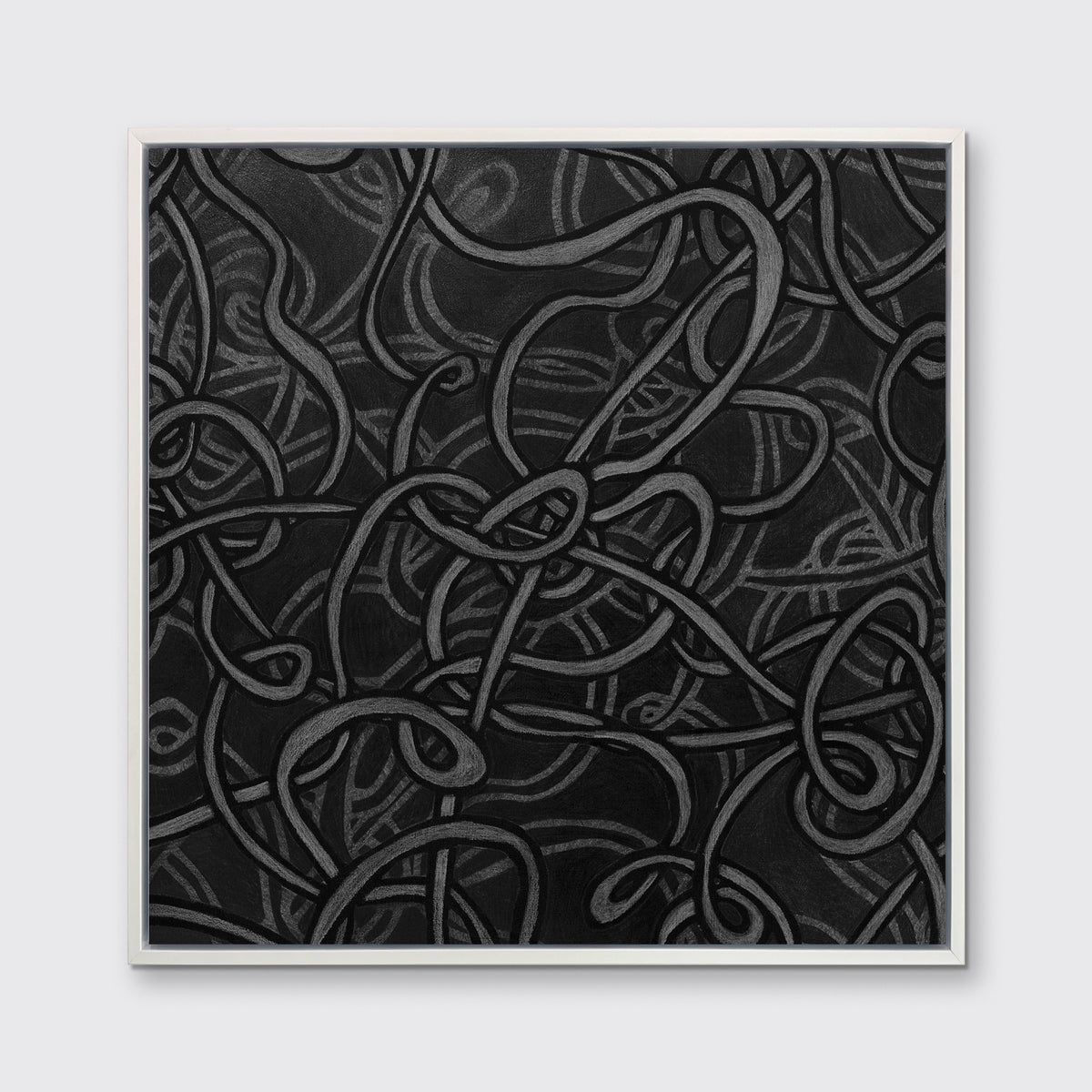 A black and grey abstract print in a white floater frame hangs on a white wall.