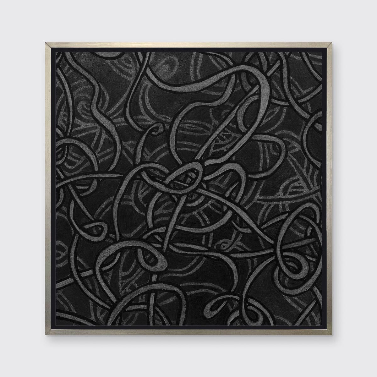 A grey and dark grey abstract print in a silver floater frame hangs on a white wall.