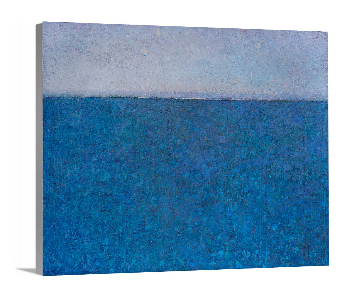 A side-angle view of a blue abstract landscape print on canvas.
