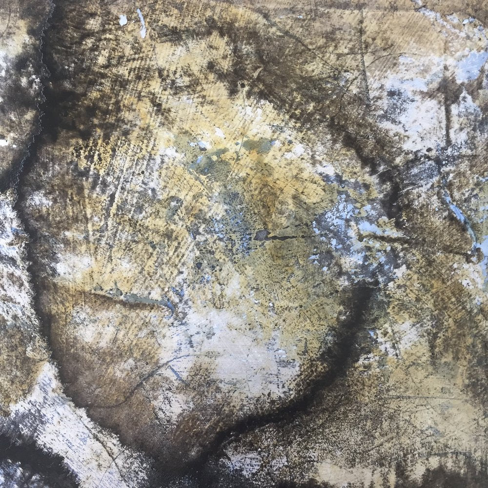 A detail and up close view of a brown, black, blue and white abstract circle painting by Roger Mudre.