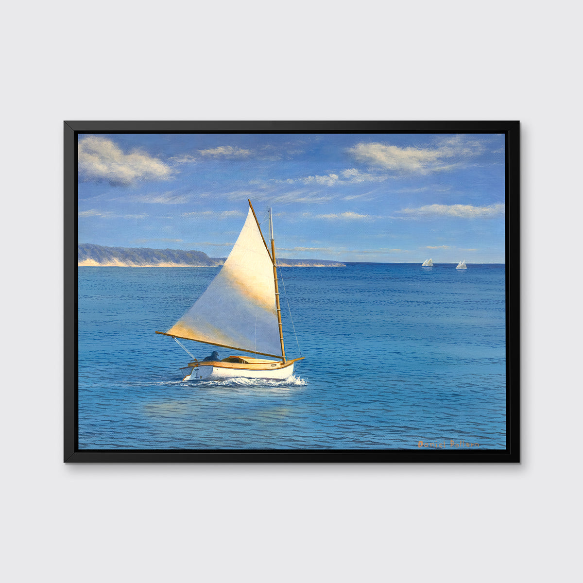 A blue, beige and white realist seascape print with a sailboat in a black floater frame hangs on a white wall.